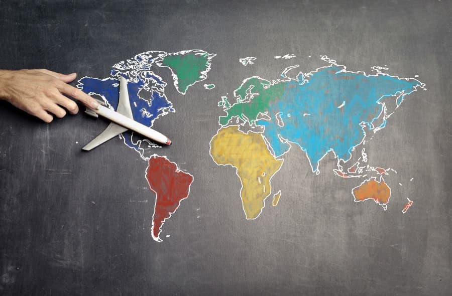 Hand placing a plane marker on a world map